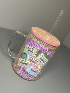 a pink and gold glittered coffee cup with a straw sticking out of the lid