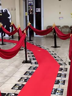 red carpeted entrance way with black and white checkered flooring, decorated with gold stars