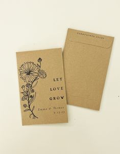 two envelopes with flowers on them sitting next to an envelope that says let love grow