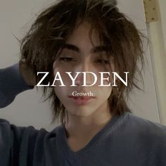 a young man with long hair is wearing a sweater and has the word zayden written on it