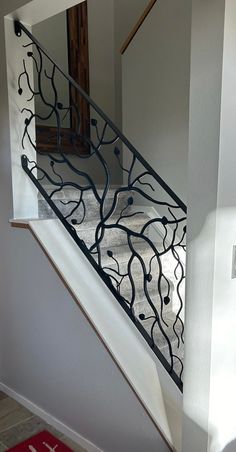 a staircase with wrought iron railing and handrail