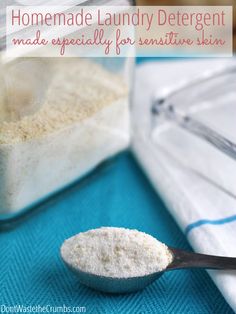 a spoon full of white powder next to a container