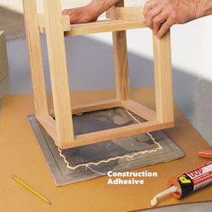 a man is working on an unfinished chair with construction adhesivee next to it