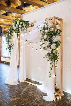 the wedding arch is decorated with greenery and white flowers stock photo - 957982