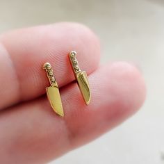 ↘️ Click: "Learn more about this item" for details. 🔪 Our tiny knife earrings are a fun and edgy addition to your jewelry collection. Crafted from sterling silver, they're the perfect way to show off your love for the culinary arts or add a punk rock vibe to your style. Ideal for 90s nostalgia or as a unique best friend gift! Check out the matching 🔪 Necklace here: https://www.etsy.com/listing/1590359497/tiny-knife-necklace-edgy-jewelry * T H E * D E T A I L S *  * Choose from Bronze with Ster Hidden Knife Jewelry, Knife Earrings, Silver Knife Jewelry, Knife Pendant, Silver Knife Necklace, Unique Best Friend Gifts, Knife Necklace, Edgy Jewelry, White Jewelry Box