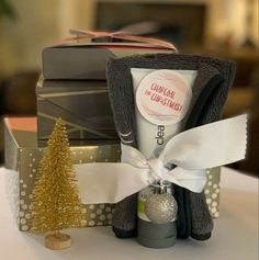 a towel, christmas tree and other items are on a white table with silver polka dots