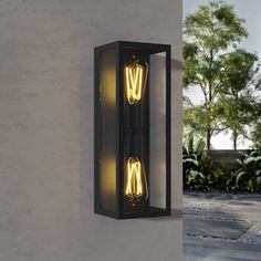 Illuminate your outdoor space with elegance and convenience with our rectangular outdoor waterproof glass wall sconce with dusk-to-dawn functionality. This sophisticated lighting solution not only adds a touch of style to your appearance but also ensures your home is well-lit and safe day or night. This modern-style wall lamp is very versatile and can be used in doorways, porches, hallways, gardens, garages, and other places. | Trent Austin Design® Jarrow 2 - Light Metal Outdoor Wall Sconce (Dus Black Scone Lights Outside, Dusk Till Dawn Porch Light, Outdoor Wall Sconces Black, Dusk To Dawn Outdoor Wall Lights, Porch Light Fixtures, Black Outdoor Wall Lights 20”h, Cfl Bulbs, Garage Lighting, Dusk To Dawn