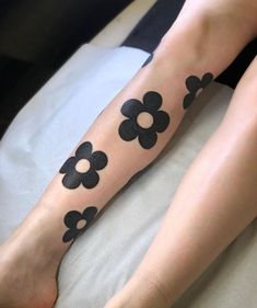 a woman's legs with black flowers on them