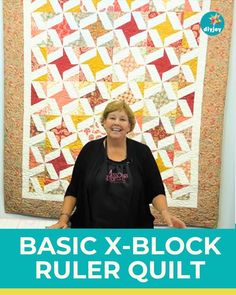 a woman standing in front of a quilt with the words basic x - block ruler quilt