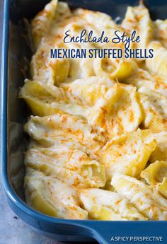 an enchilada style mexican stuffed shells in a blue casserole dish