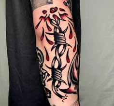 a man's arm with tattoos on it and an ink pen in the middle