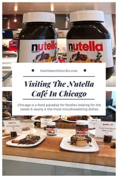 two jars of nutella sitting on top of a counter next to plates of food