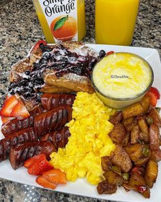 a white plate topped with different types of food next to a bottle of orange juice