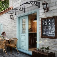 the outside of a restaurant with tables and chairs