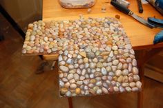 a wooden table topped with lots of rocks