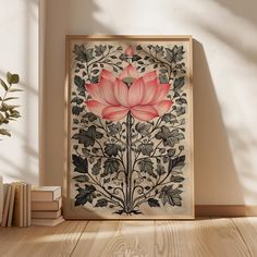 a pink flower sitting on top of a wooden table