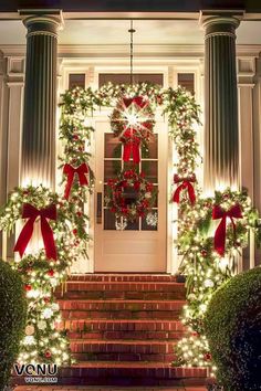 christmas wreaths on the front steps of a house decorated with red bows and lights