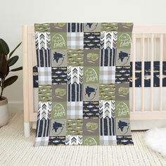 a baby crib with a blanket that has an image of a moose on it