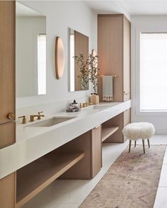 a large bathroom with two sinks and mirrors