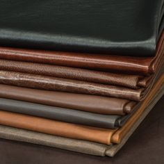 several different colored leathers stacked on top of each other