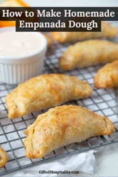 baked pastries cooling on a wire rack with oranges and dip in the background