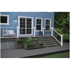 a blue house with white railings and flower boxes on the front porch, along with two planters filled with flowers