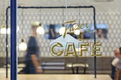 there is a sign that says fazer cafe on the glass in front of it