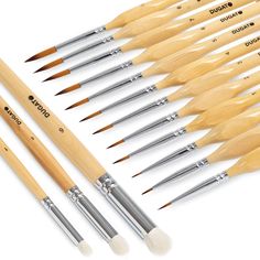 six wooden brushes are lined up next to each other