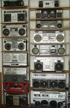 there are many different types of radio and cassette players on the shelves in this room