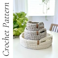 three crocheted baskets sitting on top of a table