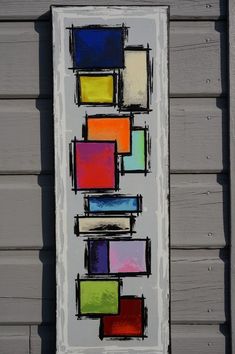 a painting on the side of a building with squares painted on it and one block missing