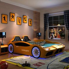 a bedroom decorated in orange and black with sports themed decor, including a bed made to look like a car