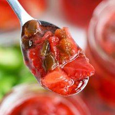 a spoon full of pickled peppers and sauce