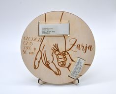 a wooden plaque with writing on it that reads zapa and has an image of a hand holding a cup