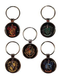 harry potter keychains are shown in four different colors and designs, including one with hogwart's crests