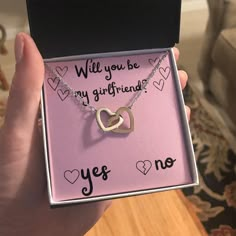 someone is holding up a box with a necklace in it that says, will you be my girlfriend?