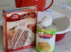 ingredients for cake sitting on top of a counter next to a red pot and white bowl