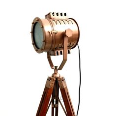 an old fashioned tripod light on a white background