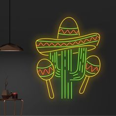 a neon sign in the shape of a cactus with sombrero and two eggs