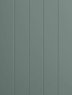 the back side of a gray wall with vertical paneling