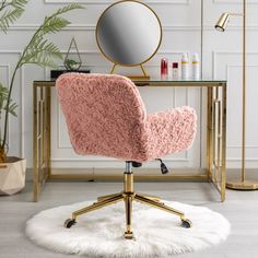 a pink chair sitting on top of a white rug in front of a desk with a mirror