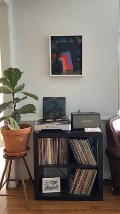 a record player sitting on top of a shelf next to a chair