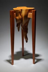 an animal head sticking out of a wooden table