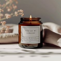 a candle sitting on top of a table next to flowers