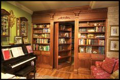 a living room filled with lots of furniture and bookshelves next to a piano