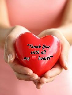 a woman holding a red heart in her hands with the words thank you with all my heart