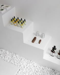 an assortment of essential oils on white steps