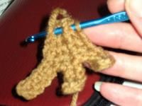 someone is crocheting a small stuffed animal with a blue pen in their hand