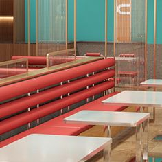 tables and benches are lined up against the wall in an empty room with blue walls