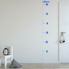 a white wall with a blue height chart on it